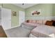 Bedroom with green walls, plush carpet, white trim, and a bright window at 2425 Giles Ln, Mount Pleasant, SC 29466