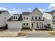 Charming two-story home featuring a welcoming front porch, attached two-car garage, and manicured landscaping at 2425 Giles Ln, Mount Pleasant, SC 29466