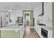 Bright, open kitchen featuring white cabinetry, stainless steel appliances, and an expansive central island at 2425 Giles Ln, Mount Pleasant, SC 29466