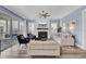 A cozy living room with fireplace, soft blue walls, ample seating and access to outdoor patio at 2425 Giles Ln, Mount Pleasant, SC 29466