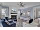 A cozy living room with fireplace, soft blue walls, ample seating and views to the outdoor space at 2425 Giles Ln, Mount Pleasant, SC 29466