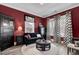 Cozy living room with dark red walls, plush rug, and decorative curtains at 2425 Giles Ln, Mount Pleasant, SC 29466