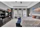 Comfortable main bedroom boasts tray ceilings, many windows with bright light, and a beautiful view of the property at 2425 Giles Ln, Mount Pleasant, SC 29466