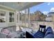 Relaxing screened-in porch with comfortable seating and a view of the serene backyard, perfect for enjoying nature at 2425 Giles Ln, Mount Pleasant, SC 29466