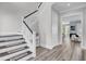 Elegant staircase with dark wood trim and white railings, showcasing open floor plan at 2425 Giles Ln, Mount Pleasant, SC 29466