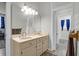 Bright bathroom with double sinks, a large mirror, and a view into an adjacent bathroom at 2514 Myrtle Ave, Sullivans Island, SC 29482