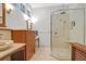 Bright bathroom featuring a glass shower, a wooden cabinet with a marble countertop, and modern fixtures at 2514 Myrtle Ave, Sullivans Island, SC 29482