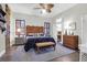 Cozy bedroom with beautiful wooden details, lamps, a ceiling fan and a comfortable sitting area at 2514 Myrtle Ave, Sullivans Island, SC 29482