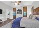 Spacious bedroom with wooden accents, lamps, ceiling fan and access to an ensuite bathroom at 2514 Myrtle Ave, Sullivans Island, SC 29482