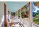 Spacious covered porch featuring stylish seating and scenic views at 2514 Myrtle Ave, Sullivans Island, SC 29482