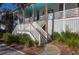Classic covered front porch with steps leading to a white exterior home at 2514 Myrtle Ave, Sullivans Island, SC 29482