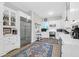Spacious white kitchen featuring stainless steel appliances, wooden floors with area rugs and a bright window at 2514 Myrtle Ave, Sullivans Island, SC 29482