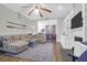 Open-concept living area with ship lap walls, fireplace, and view into the dining area at 2514 Myrtle Ave, Sullivans Island, SC 29482