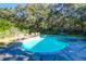 Beautiful backyard pool and patio area surrounded by mature trees at 2514 Myrtle Ave, Sullivans Island, SC 29482