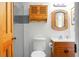 Cozy bathroom features a walk-in shower, toilet, vanity sink, and a charming wooden cabinet at 278 Driftwood Ln, Edisto Island, SC 29438