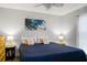 Bright bedroom with a wave art piece and a comfortable bed with side tables at 278 Driftwood Ln, Edisto Island, SC 29438