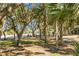 Golf course surrounded by trees and golf carts are parked in the distance at 278 Driftwood Ln, Edisto Island, SC 29438