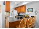 Charming kitchen features wooden cabinets, modern countertops, breakfast bar, and beach-themed decor at 278 Driftwood Ln, Edisto Island, SC 29438