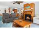 Open-concept living room with a wood-burning fireplace, comfortable seating, and views of the adjacent kitchen at 278 Driftwood Ln, Edisto Island, SC 29438