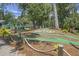 Fun mini golf course with winding paths and tropical landscaping, creating an engaging recreational space at 278 Driftwood Ln, Edisto Island, SC 29438