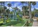 A playground with a variety of play equipment for in a verdant outdoor setting with mature trees at 278 Driftwood Ln, Edisto Island, SC 29438