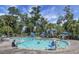Large outdoor pool surrounded by lounge chairs and tropical landscaping on a sunny day at 278 Driftwood Ln, Edisto Island, SC 29438