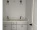 Modern bathroom featuring a double vanity with sleek fixtures and clean lines at 2988 Lodge Berry Ln, Johns Island, SC 29455