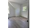 Bright and spacious bedroom with hardwood floors and natural light from two windows at 2988 Lodge Berry Ln, Johns Island, SC 29455