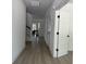 Bright hallway with white trim, wood-look floors, and view of stairs and game room at 2988 Lodge Berry Ln, Johns Island, SC 29455