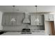 Kitchen island featuring white marble countertops and gray cabinets at 2988 Lodge Berry Ln, Johns Island, SC 29455