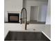 Kitchen sink area with a modern faucet, undermount sink, and view of the fireplace at 2988 Lodge Berry Ln, Johns Island, SC 29455