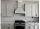 Well-appointed kitchen with stainless steel appliances, tile backsplash, and gray cabinets at 2988 Lodge Berry Ln, Johns Island, SC 29455