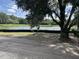 Scenic view of a pond bordered by trees and a black fence on a sunny day at 2988 Lodge Berry Ln, Johns Island, SC 29455