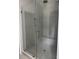 Large walk-in shower with gray tile and a built-in shower bench features a seamless glass door at 2988 Lodge Berry Ln, Johns Island, SC 29455