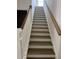 Classic white staircase with wood treads and a railing leads to the upper level of the home at 2988 Lodge Berry Ln, Johns Island, SC 29455