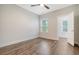 Neutral bedroom with a ceiling fan, hardwood floors, and ample natural light at 3092 Emma Ln, Mount Pleasant, SC 29466