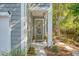 Charming front entrance with a gray door, decorative wreath, and a well-maintained landscaped yard at 3092 Emma Ln, Mount Pleasant, SC 29466