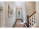 Bright hallway with wood floors, a decorative rug, and a staircase leading to the upper level of the house at 3092 Emma Ln, Mount Pleasant, SC 29466
