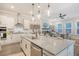 Open-concept kitchen with a large island, pendant lighting, and seamless flow into the living area at 3092 Emma Ln, Mount Pleasant, SC 29466