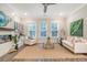 Cozy living room boasts a fireplace, built-in cabinets, and comfortable seating with natural light from large windows at 3092 Emma Ln, Mount Pleasant, SC 29466