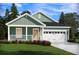 Charming single-story home with a quaint front porch and attached two-car garage at 330 Calm Water Way, Summerville, SC 29486