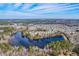 Expansive aerial view showing a community surrounding a large pond with serene landscapes and neighborhood design at 339 Cicadas Song, Moncks Corner, SC 29461