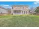 Spacious backyard with the rear exterior view of the home and screened-in porch at 339 Cicadas Song, Moncks Corner, SC 29461