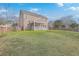 Grassy backyard with the back of the home that features a screened-in porch at 339 Cicadas Song, Moncks Corner, SC 29461