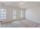 Bedroom featuring carpet, two windows and an outside door at 339 Cicadas Song, Moncks Corner, SC 29461