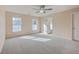 Spacious bedroom featuring two windows, a ceiling fan, and neutral carpeting at 339 Cicadas Song, Moncks Corner, SC 29461