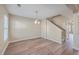 Bright dining room with hardwood floors, neutral walls, a chandelier, a large window and stairs at 339 Cicadas Song, Moncks Corner, SC 29461