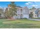 Charming two-story home with a front porch, a second story balcony and a green lawn at 339 Cicadas Song, Moncks Corner, SC 29461