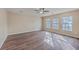 Bright living room with hardwood floors, neutral walls, a ceiling fan, and three large windows at 339 Cicadas Song, Moncks Corner, SC 29461