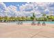 Large community pool surrounded by lounge chairs and mature trees, perfect for relaxation and recreation at 339 Cicadas Song, Moncks Corner, SC 29461